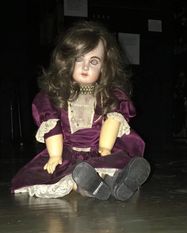 Sitting on eerily, Ayda , a haunted doll featured at the Museum of Shadows in Plattsmouth, Neb., awaits visitors of the museum. She is one of the more popular items featured and is one half of a haunted doll duo located at the museum. 
