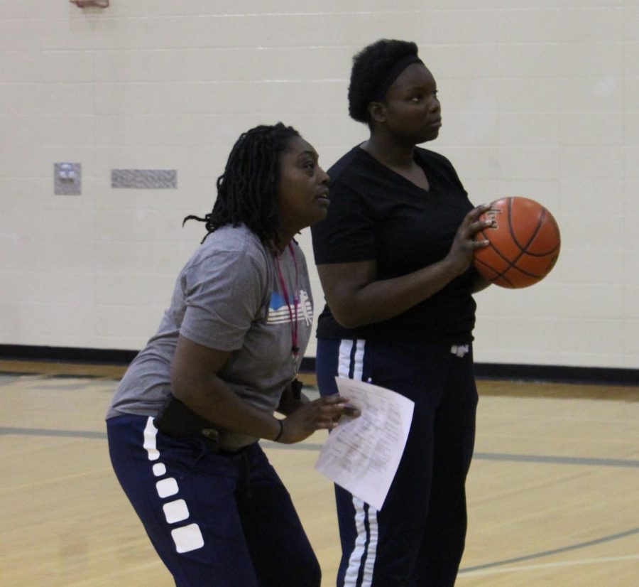 New girls basketball coach Nicole Mitchell works with senior Teana Carter at their Dec. 3 practice. Mitchell has worked with organizations like Team Nebraska and lead undefeated teams like the Lady Jaguars.