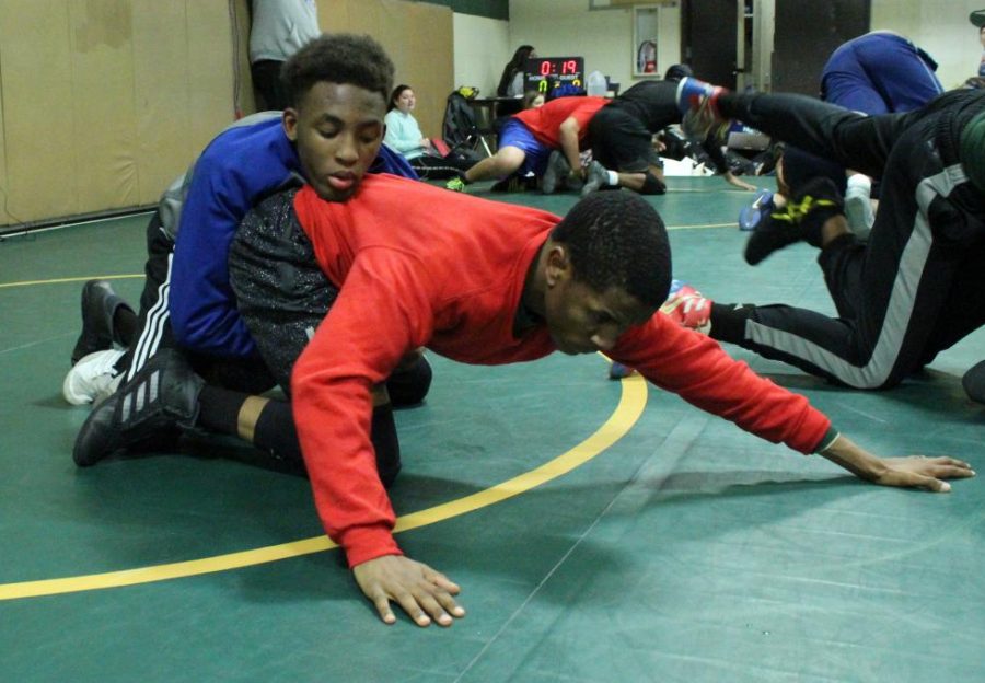 Trying to find the other’s weaknesses, Noor Salat (bottom) and Ladamien Sturdivant (top) work on top-bottom drills at  wrestling practice.