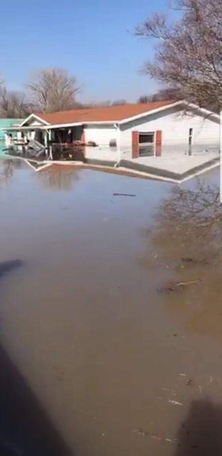 After being forced to leave his home due to dangerous conditions and rising water, Bellevue Police Offercers take photos of senior Michael Kuhn’s home which became completely engulfed by flood waters by March 18.