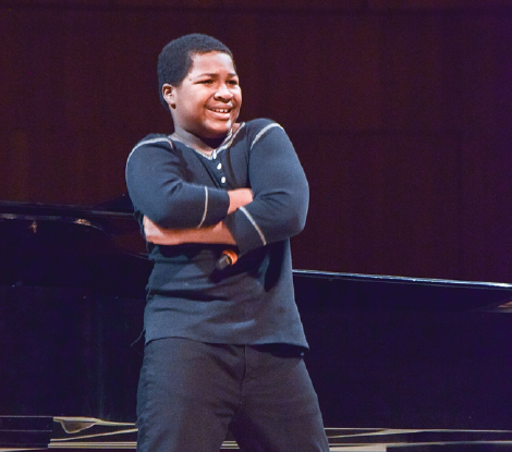 osing in front of the audience at the “Living The Dream,” competition at the Holland Performing Arts Center on Jan. 21, James Williams and his friends Mohamid Ibrahim and Londyn Henry perform their Donald Trump diss rap in front of the standing and cheering audience.
