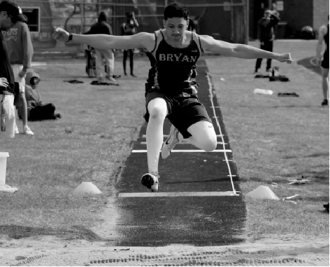 At Millard West on April 9, junior Christopher Rodriguez makes his jump in the long jump competition. Rodriguez earned a personal best with a jump of 15’7.”
