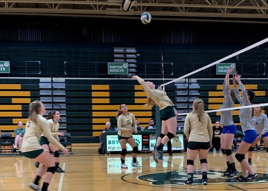 Attempting to hit the ball, junior Kaitlyn Schwenn jumps up and attacks. Although she missed the ball, Schwenn went on to have multiple blocks and kills in the game.