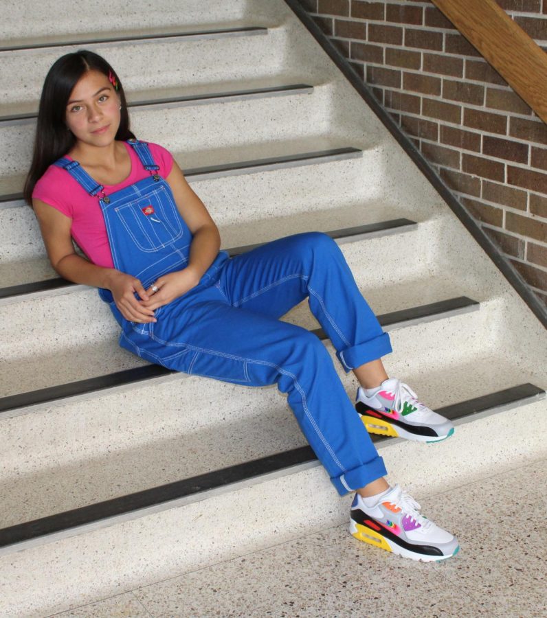 Relaxing on the stairs, Ruby Bugarin Arce looks up with confidence in her outfit. At home she decided to get the shoes because of all the colors on them, knowing that they would look good with a lot of her outfits. 