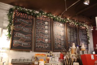  Bringing her own chalk to create the menu with visuals and fonts Manager, Alyssa Bussu has been updating the Sozo’s Coffeehouse menu for five years. 
