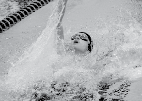 At the varsity swim meet at Omaha South High Magnet on Dec. 5, sophomore Micah Heyen swims the  100 meter backstroke.  Heyen ended up getting disquallifed from the race because he failed to touch the wall.