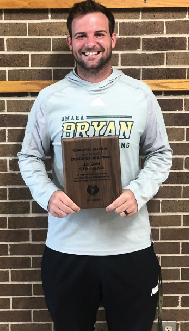 After being awarded Coach of the Year, head wrestling coach Jason Susnjar poses with his plaque for a photograph outside the gym in August. 
