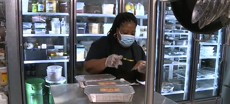 Preparing meals as part of Omaha Loco’s meal program on Jan. 9 Gladys Harrison  owner of Big Mama’s does her part in delivering the 7,000 meals they delivered to families.