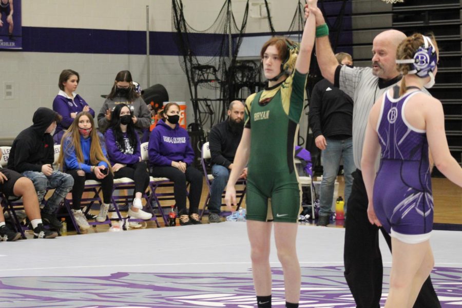 At the Bellevue East wrestling meet, senior Layna Blankenship stands tall and fiercely looks into the crowd and audience member after beating her opponent from Bellevue East, one of the many wins Blankenship had.