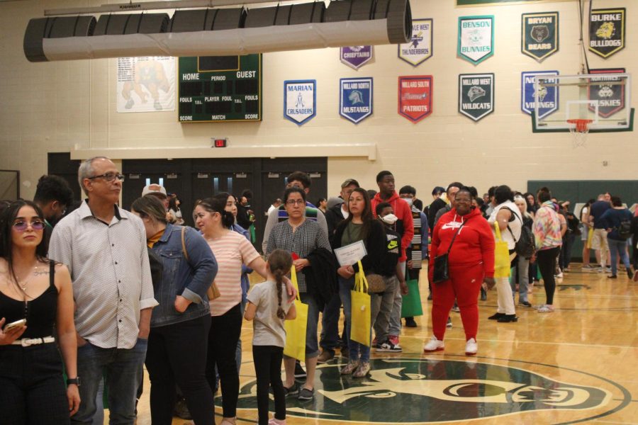 After picking up their awards, seniors and their families line up in the gym for pictures.