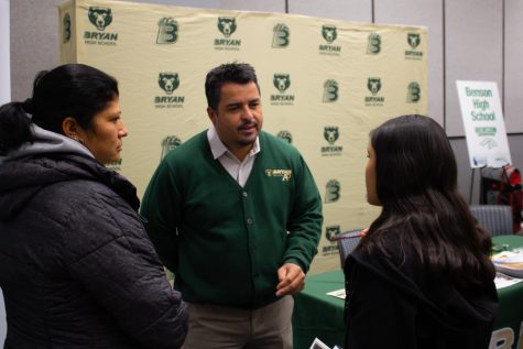 Speaking to a prospective student, principal Dr. Rony Ortega answers questions about the school at the OPS 8th Grade High School Showcase in the Scott Conference Center.  