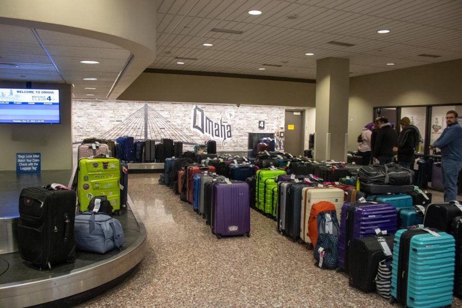 Dozens of bags sit unclaimed at Southwests baggage claim carousel at Eppley Airfield. As thousands of flights were canceled nationwide, the airline attempted to send as many bags as possible to their final destination many of which were sent separately from their passengers. Some arriving passengers were able to get a hold of their bags after their arrival while others arrived before their bags. Southwest employees told passengers whose bags were not at the airport to wait in line at the check-in counter to figure out where their bags were. 
