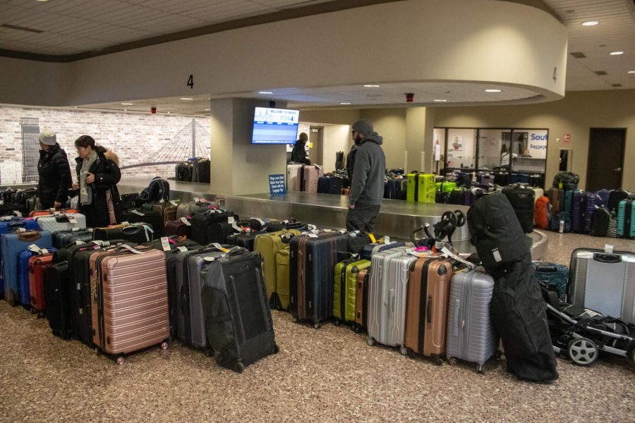 Arriving passengers search for their luggage among the dozens of other unclaimed bags at Eppley Airfield on Dec. 27, 2022.