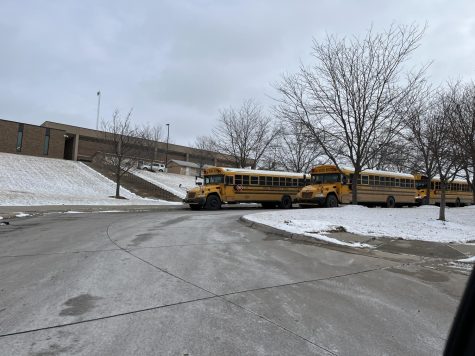 Seatbelts everyone! Buses line up at the west side of the school waiting to take kids home on the last day of the first semester.  