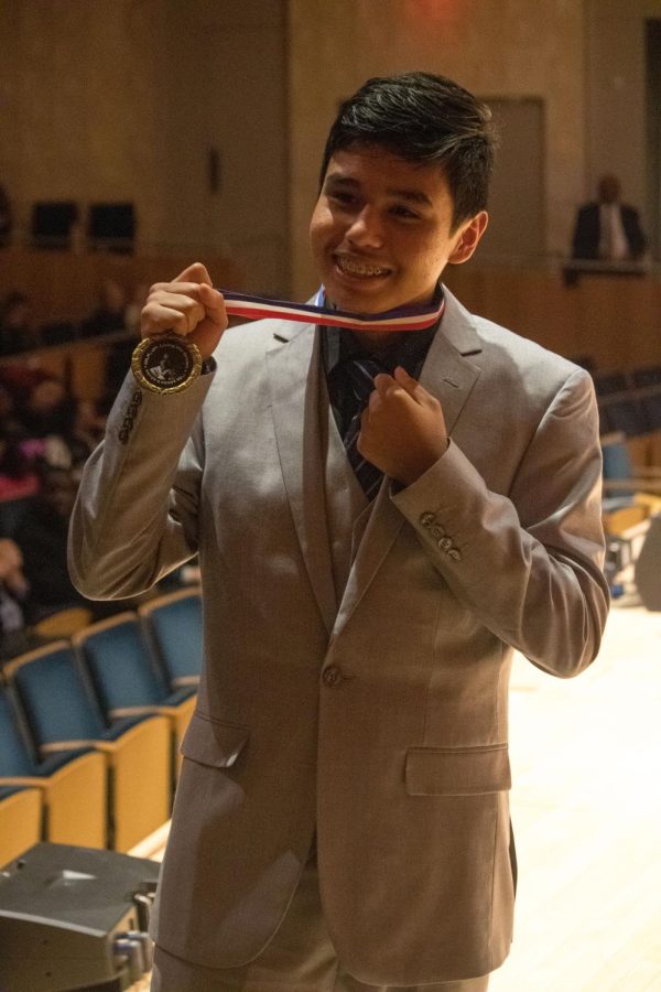 Freshman Johnathan Mendoza receives the Mayors Honor Roll Medallion for his speech on the experiences and mistreatment of undocumented immigrants. 