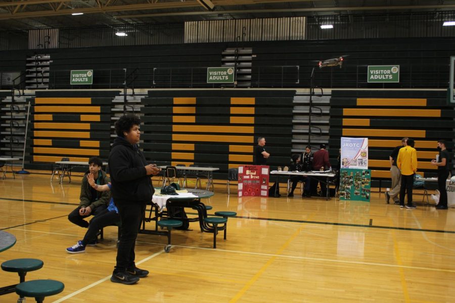 Senior Kevin Ruiz flies a drone to show 8th graders and their families opportunities the robotics club offers. 