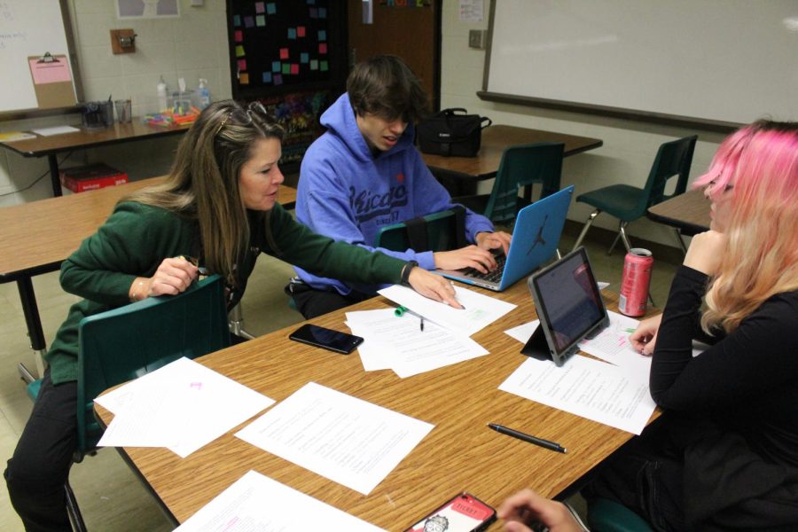 Giving support, English Teacher Jill Stephenson gives assistance to seniors Dylan Struckmeyer and Charlotte Strazdas on a group assignment.  