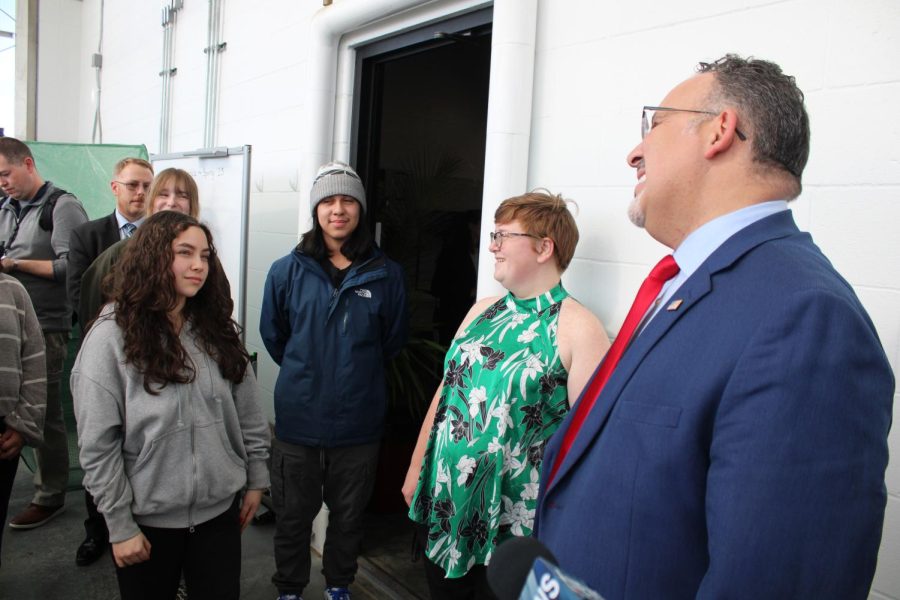 Junior Isabel Rueda-Andrades speaks to Secretary of Education Miguel Cardona about her experience in the Urban Agricultural academy during his tour of the greenhouse. 