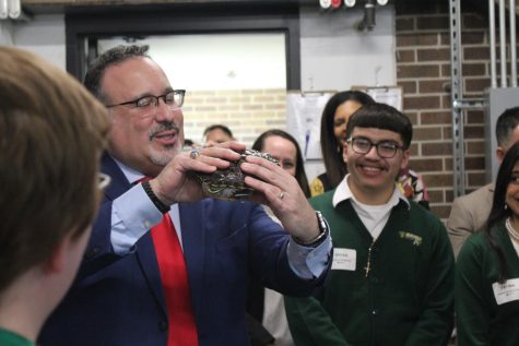 Secretary of Education Miguel Cardona holds Oogway, the Urban Agriculture’s turtle, during his visit to the school on Feb 8, 2023.  