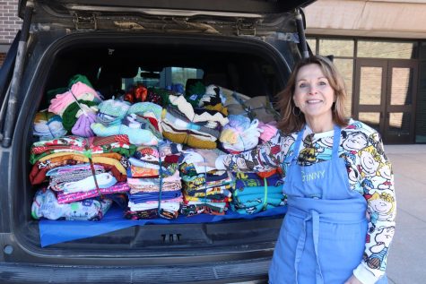 Project Linus Omaha Chapter Coordinator Ginny Debates stands in front of her SUV full of blankets made on March 5, 2023. The blankets were delivered to Offutt Air Force Base. 