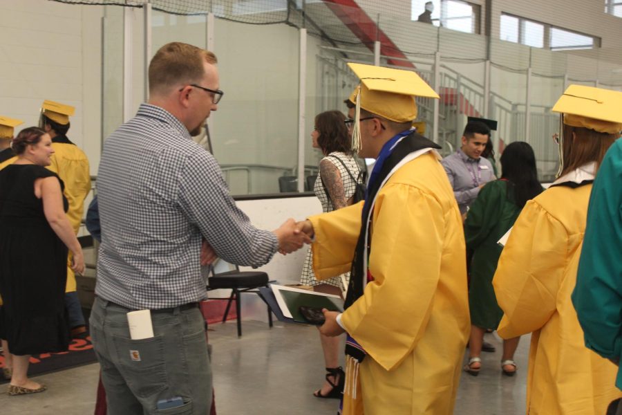 Mr.Wendell talks with graduate after the ceremony. 