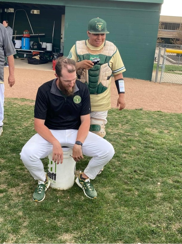 Senior+catcher+Jaden+Mcgill+seen+with+a+childish+grin+while+shaving+head+coach+David+Ashbys+head.+We+definitely+felt+excited+to+do+that.+Mcgill+said.+I+did+think+the+goal+to+win+five+games+was+hard.+